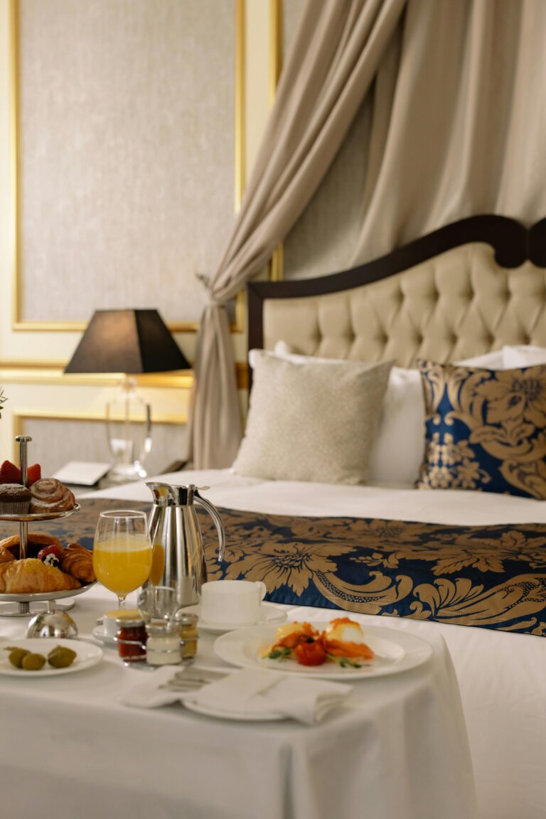 Elegant hotel room featuring a sumptuous breakfast spread with warm lighting decor.